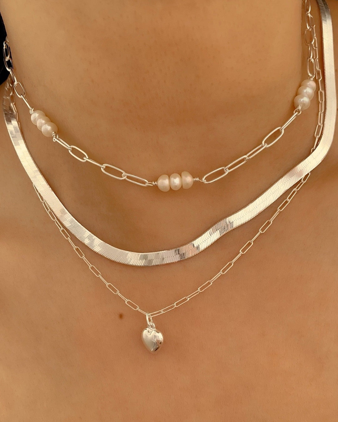 Sterling Silver Puffy Love Heart Pendant on a silver paperclip necklace chain on a model