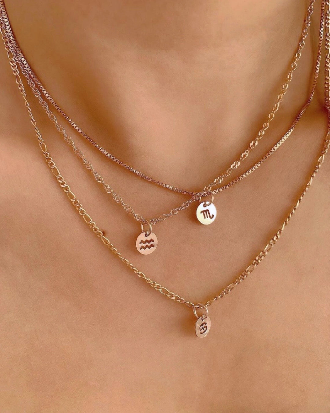 14k gold fill small zodiac sign coin pendant charms with a satellite chain necklace on a model