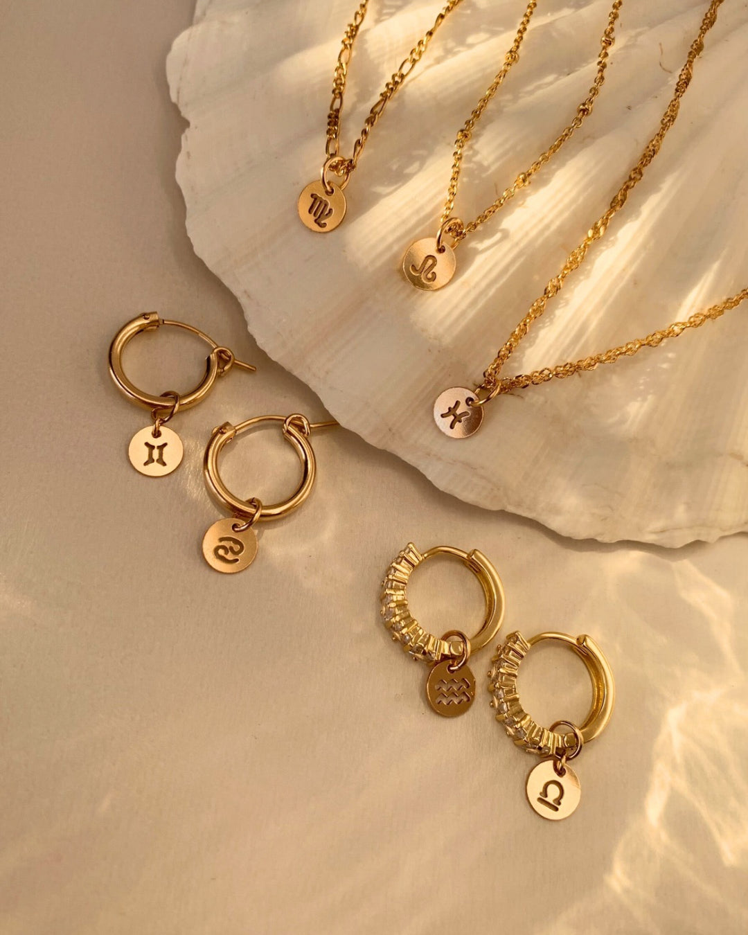 14k gold fill small zodiac sign coin pendant charms with a satellite chain necklace on a model