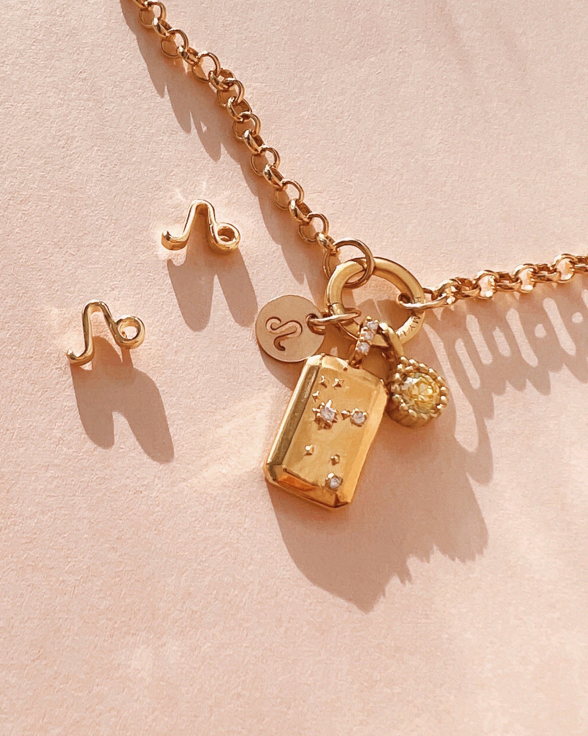 Gold Leo Constellation Zodiac Pendant on a Gold Rolo Annex Link Necklace Chain and August Peridot Birthstone Pendant