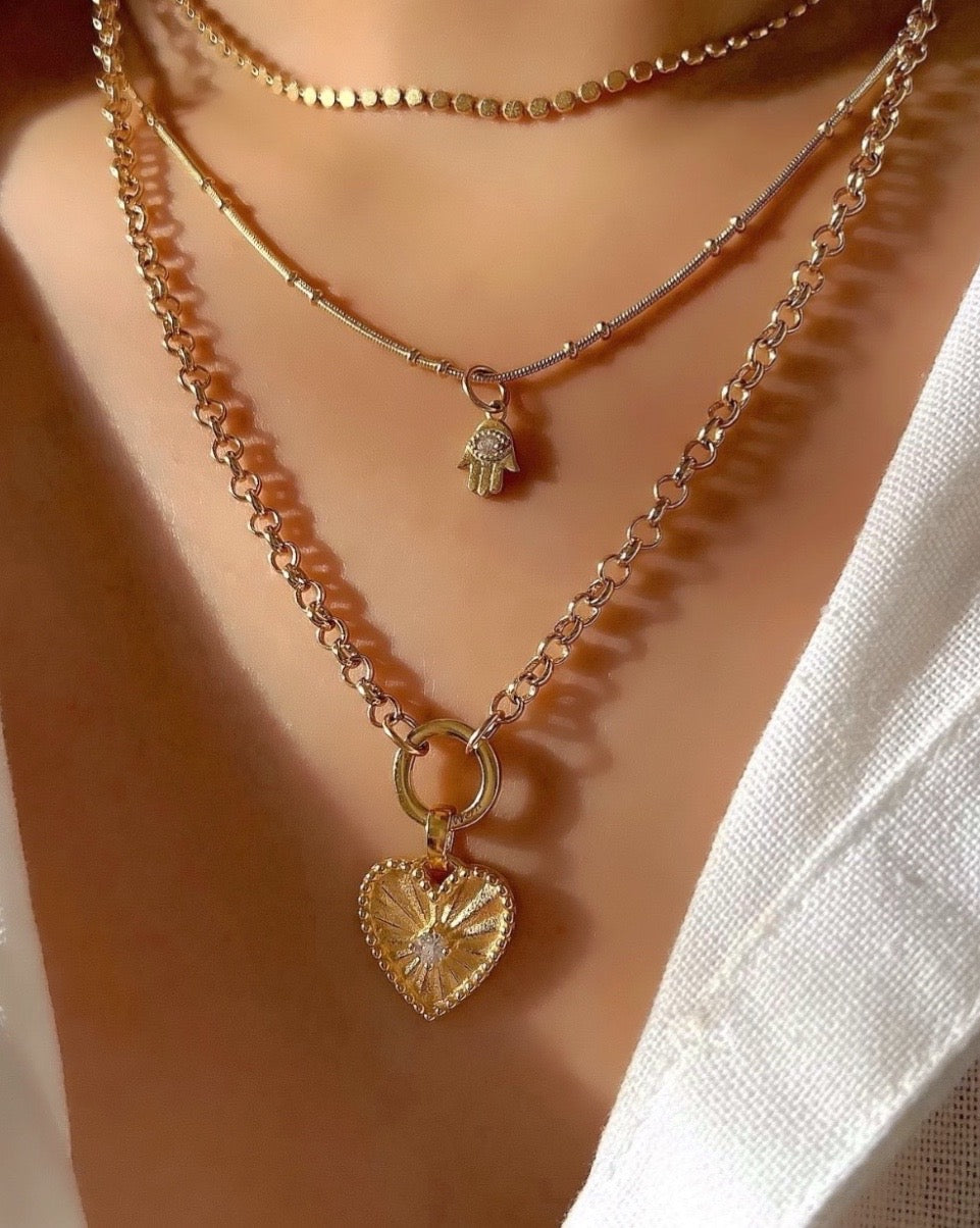 14k gold fill love heart pendant with diamond cubic zirconia centre with a Rolo annex link necklace chain on a model