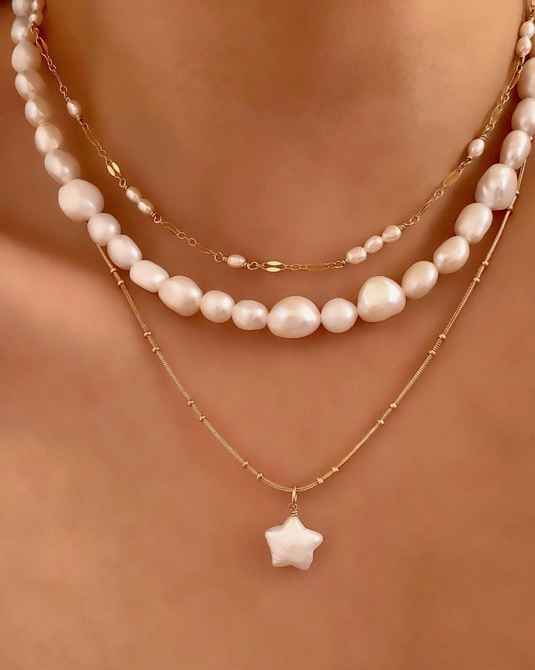 Freshwater Pearl Star pendant on a gold fill bead necklace chain on a model