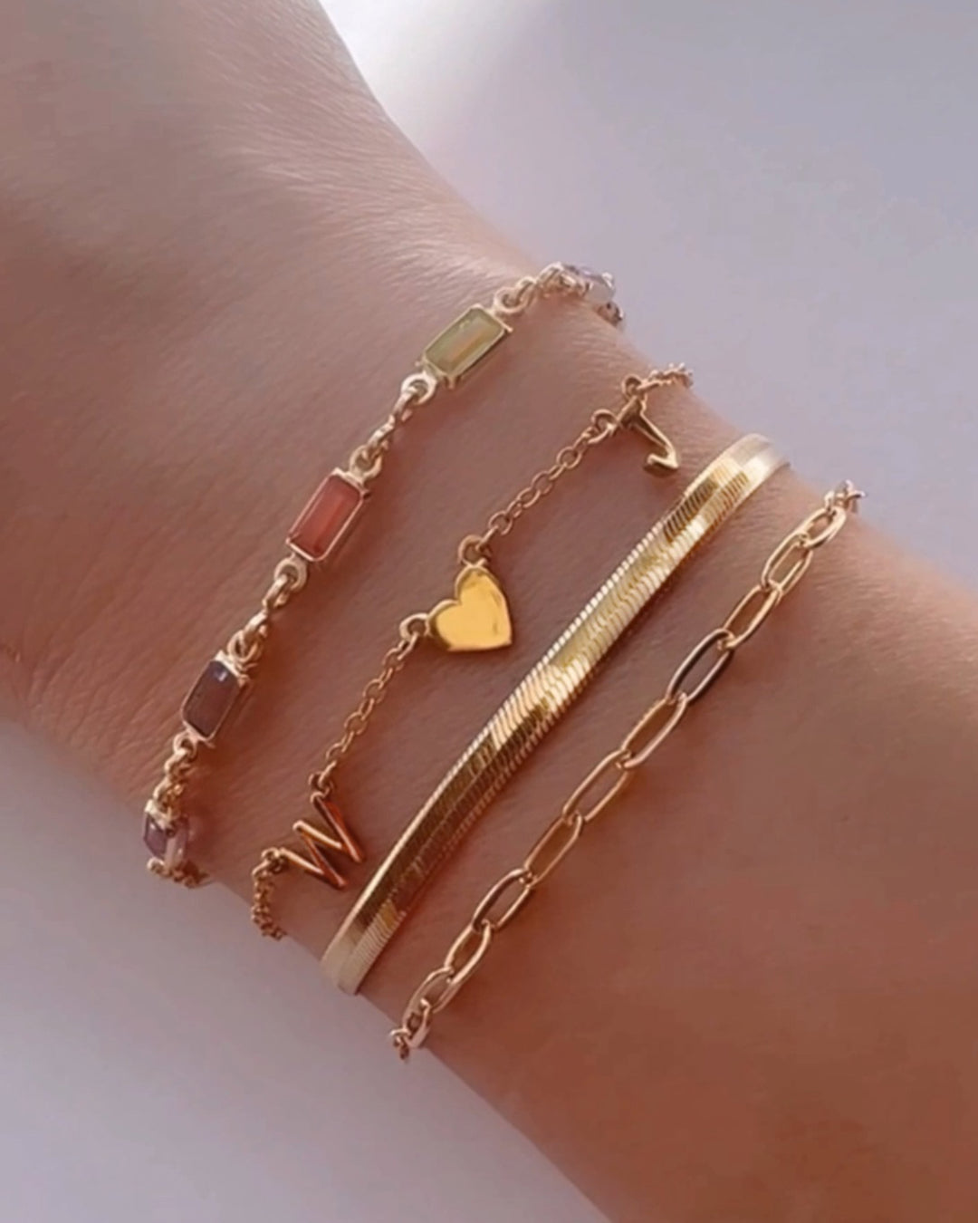 Gold fill bracelet in pink, blue and purple bezel gems on a model