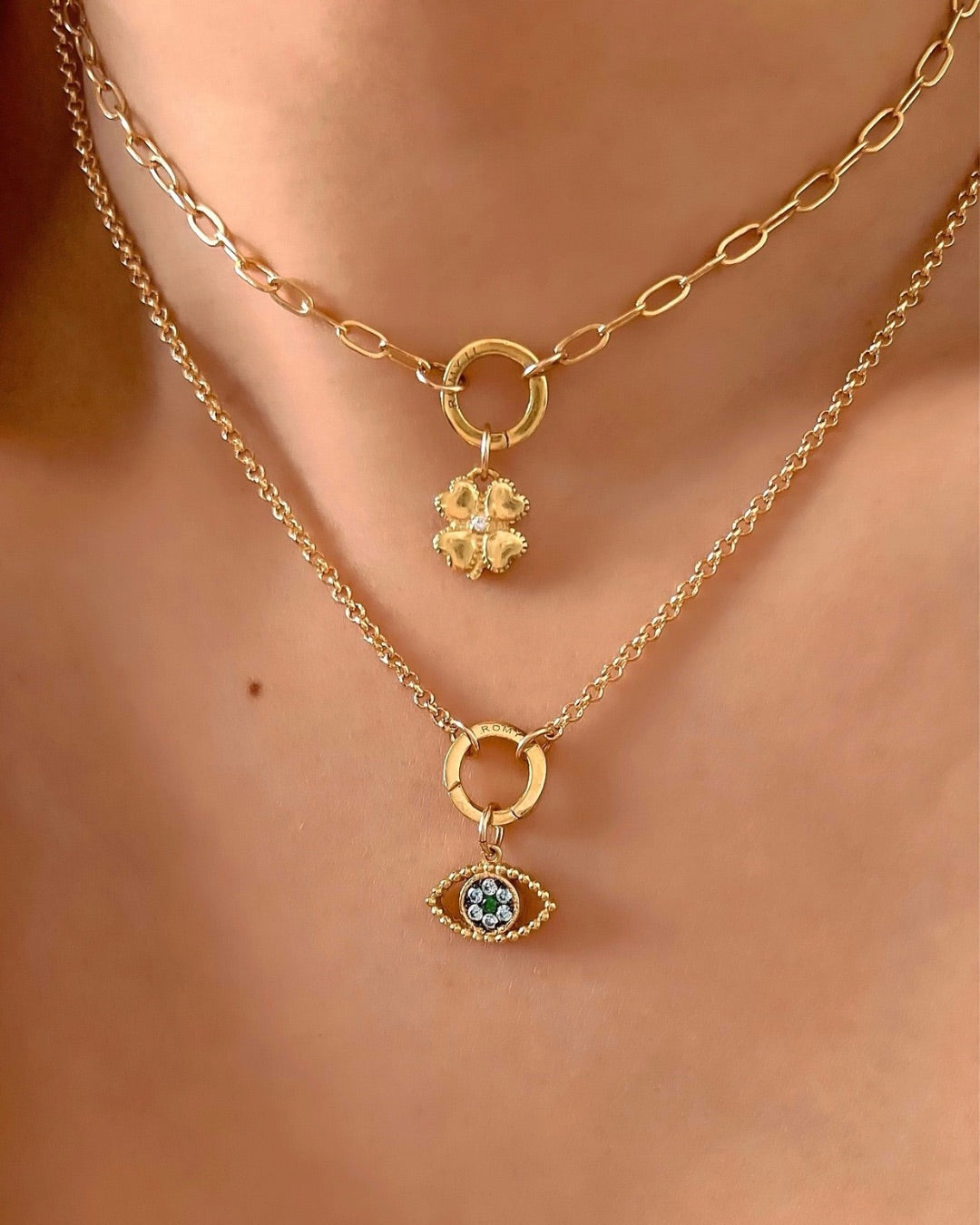 Gold petite Rolo annex link clasp necklace chain with evil eye pendant on a model