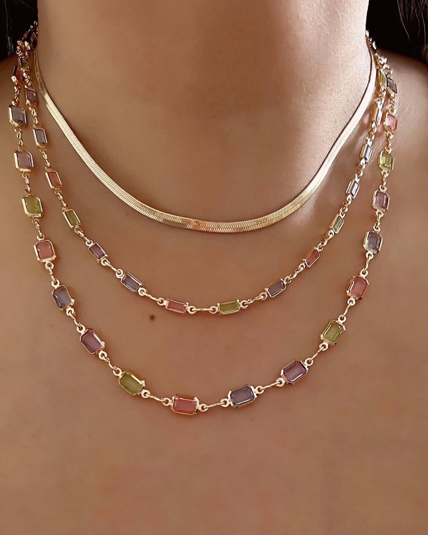 Petite Gold fill necklace in pink, blue and purple bezel gems on a model