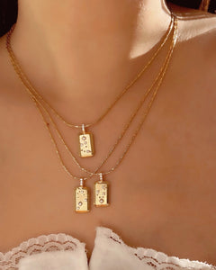 Gold Aquarius Constellation Zodiac Pendant on a Gold Necklace Chain on a model 
