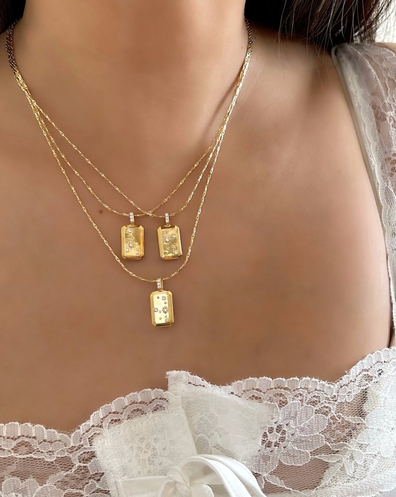 Gold Cancer Constellation Zodiac Pendant on a Gold Necklace Chain on a model