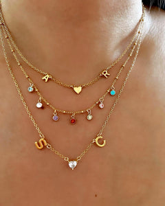 Customizable initial necklace with the option to add up to 7 letters, gems or heart