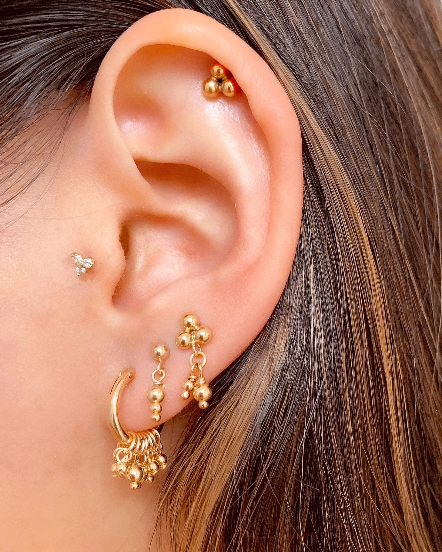 14k gold fill elemental linear sphere earring studs on a model 
