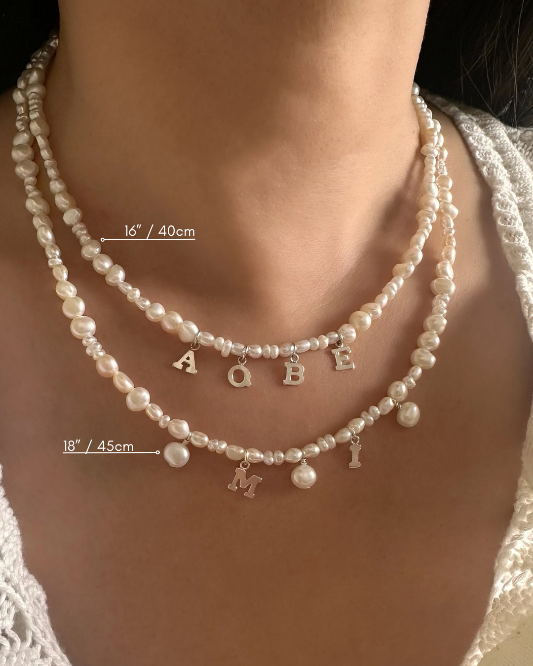 Pearl Initial necklaces with letter charms on a person's neck, showing 16” / 40cm and 18” / 45cm length measurements.