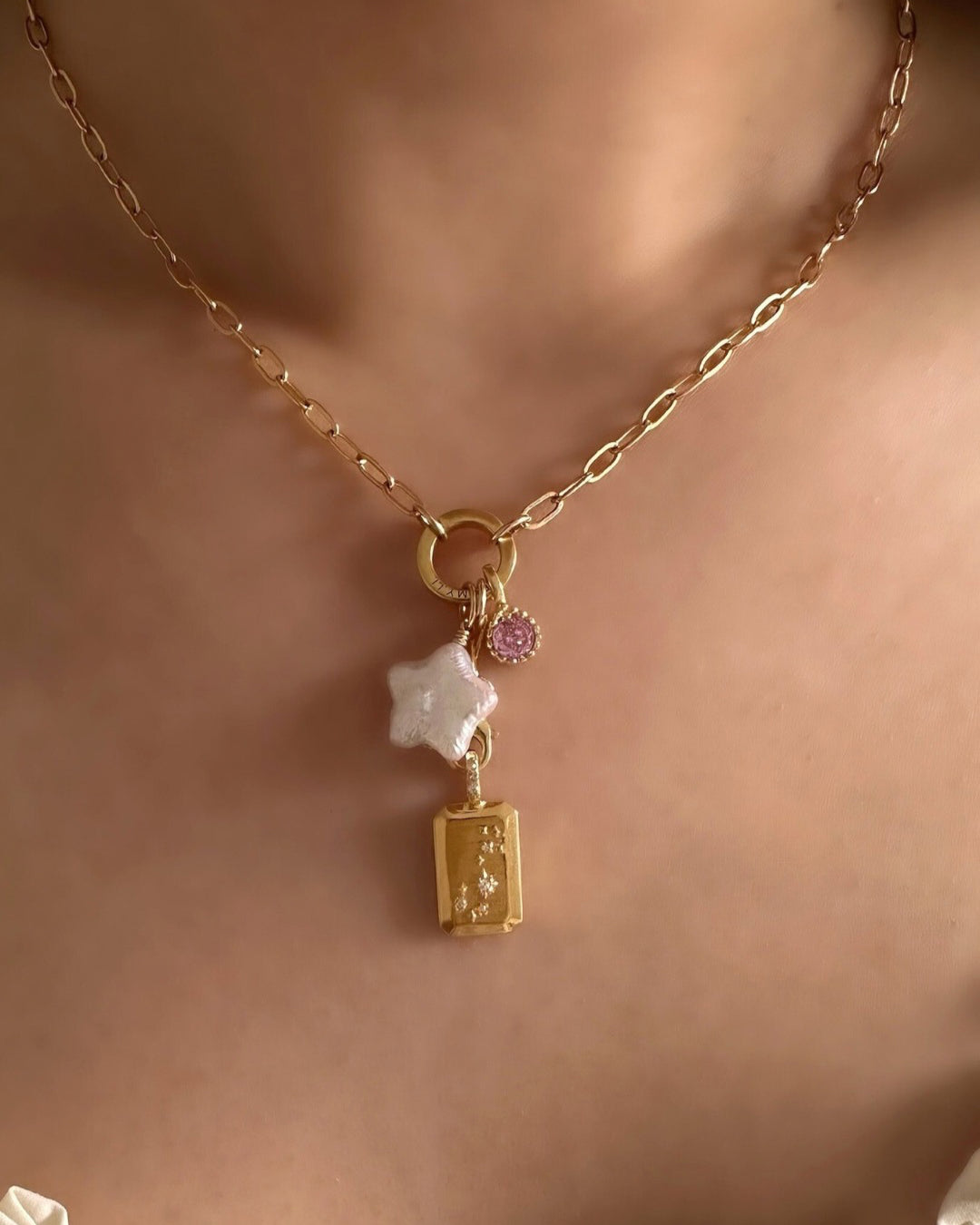 Model wearing Romyli Mix & Match Pendants with Paperclip Annex Link Necklace. Scorpio Constellation Pendant with Paperclip Pendant Chain Connector, Star Pearl Pendant and October Birthstone (Tourmaline) Pendant 