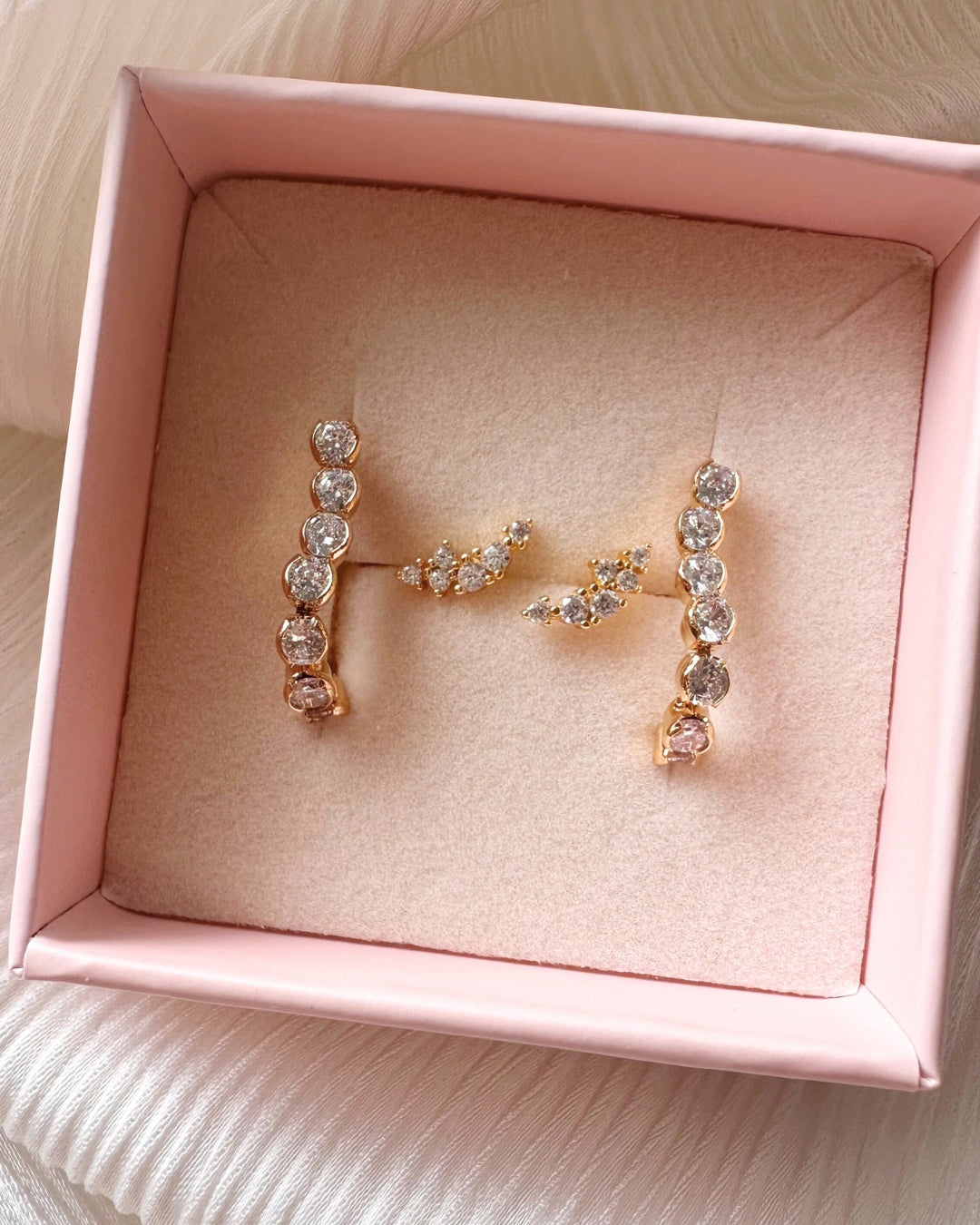 Tennis chain stud earrings with Fleck Curve Studs in a Romyli gift box. 