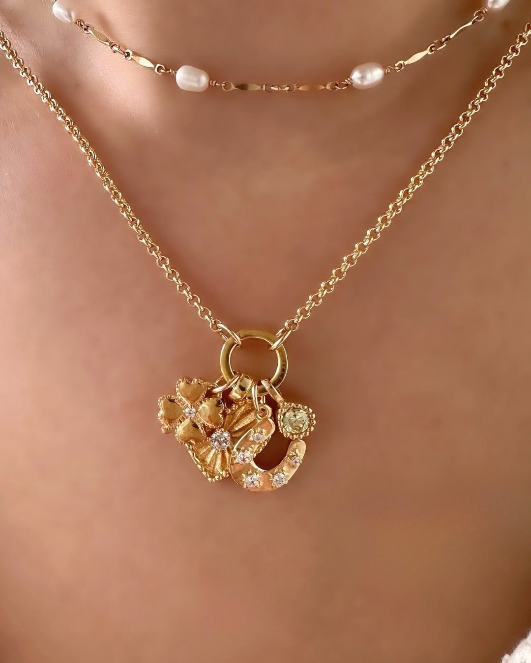 Petite Rolo Annex Link Necklace paired with Heart Token Pendant, Clover Pendant, Horseshoe Pendant, and March Aquamarine Birthstone Pendant. Layered with Opalene Pearl Choker on Model 