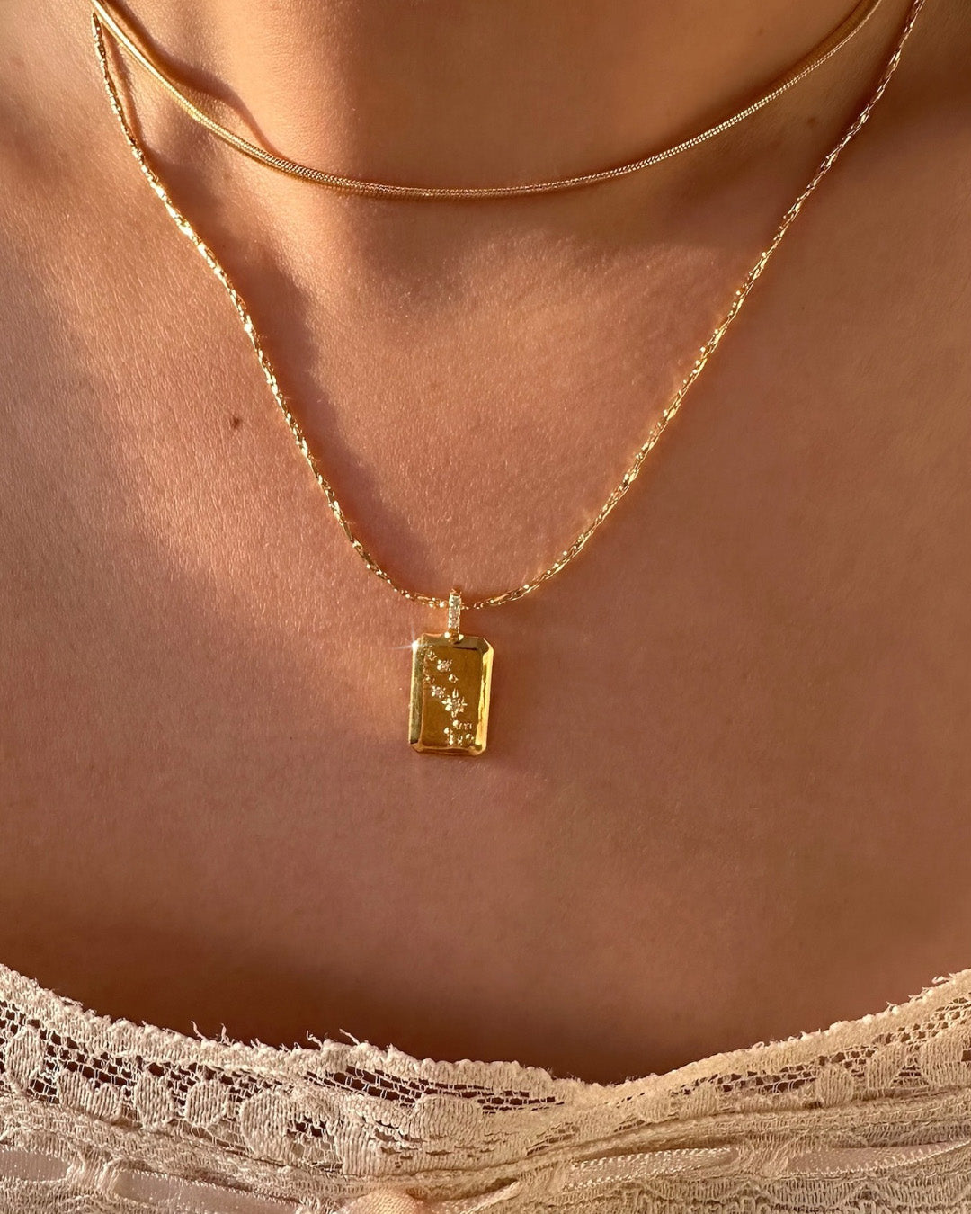 Gold taurus constellation zodiac necklace on a model 
