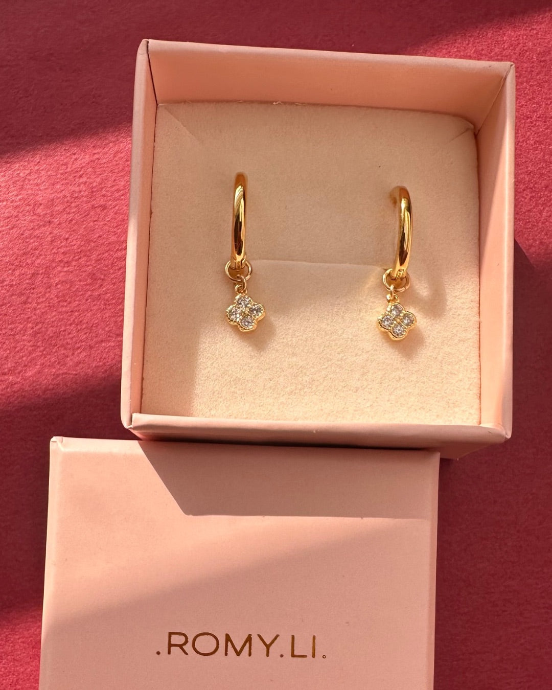 Gold Mini Clover Charm Hoops in a pink Romyli gift box 
