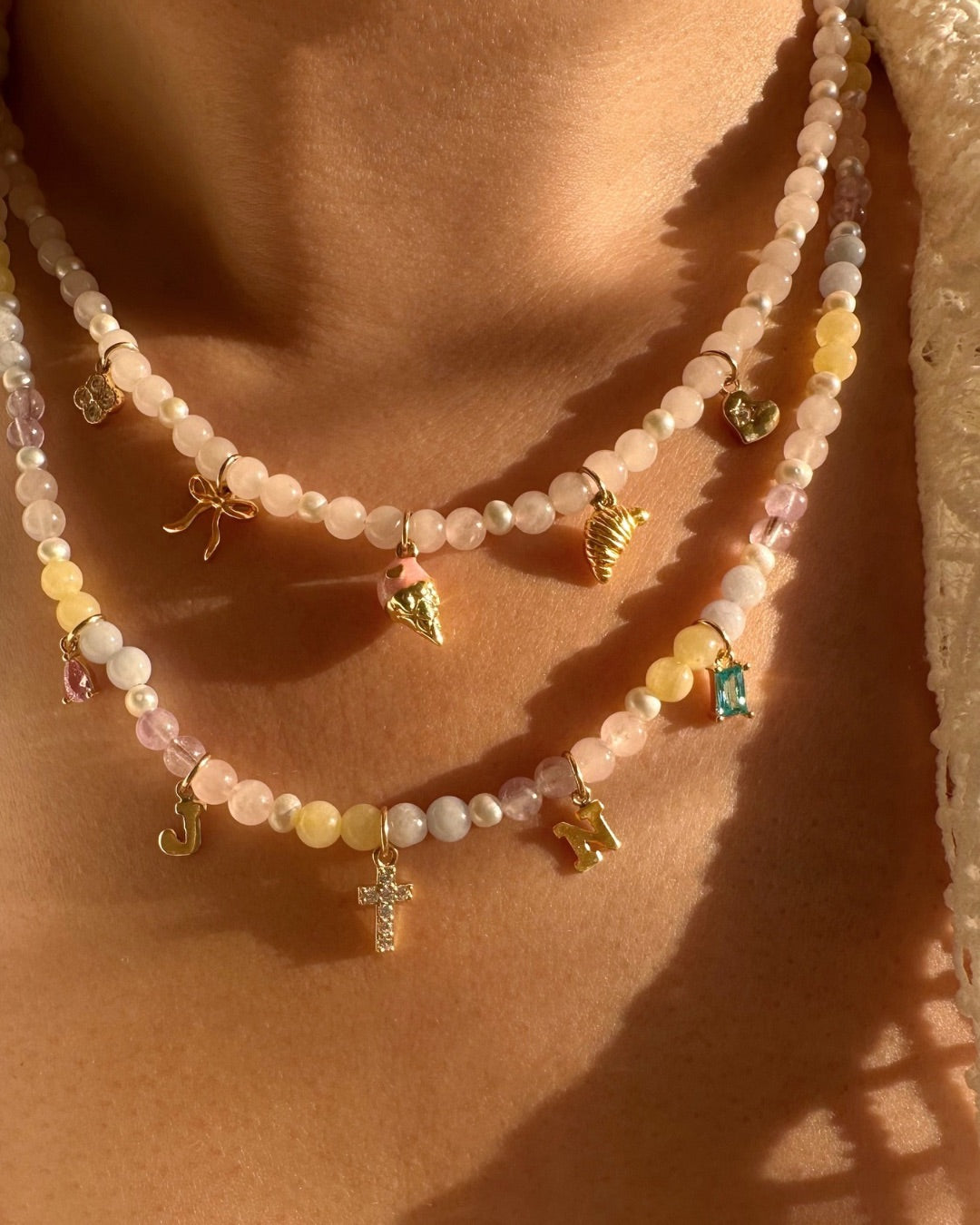 Necklace with colorful gemstone charm necklaces and charms on a person's neck