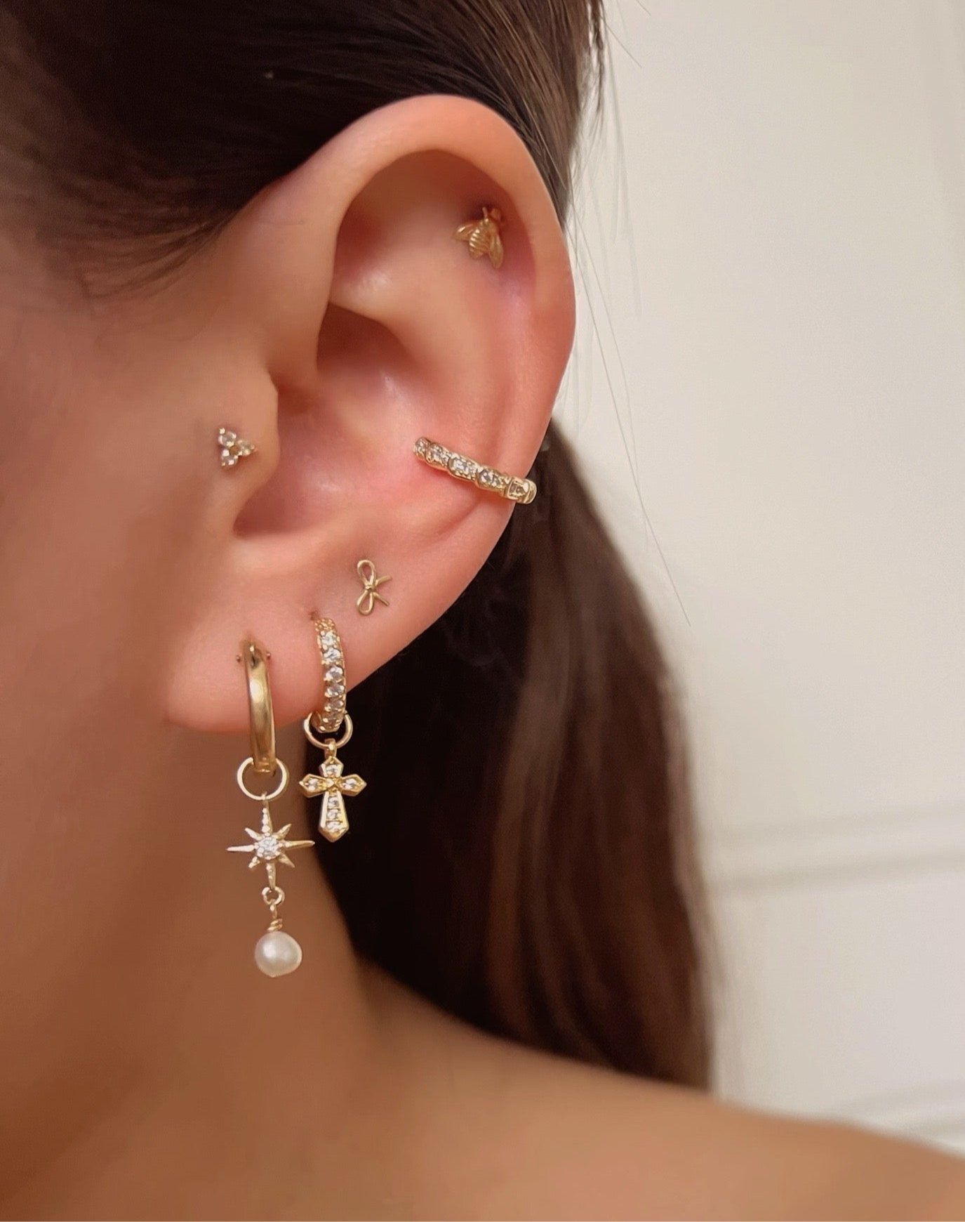 Gold Clarity Ear Cuff with pave cubic zirconia crystals on a model