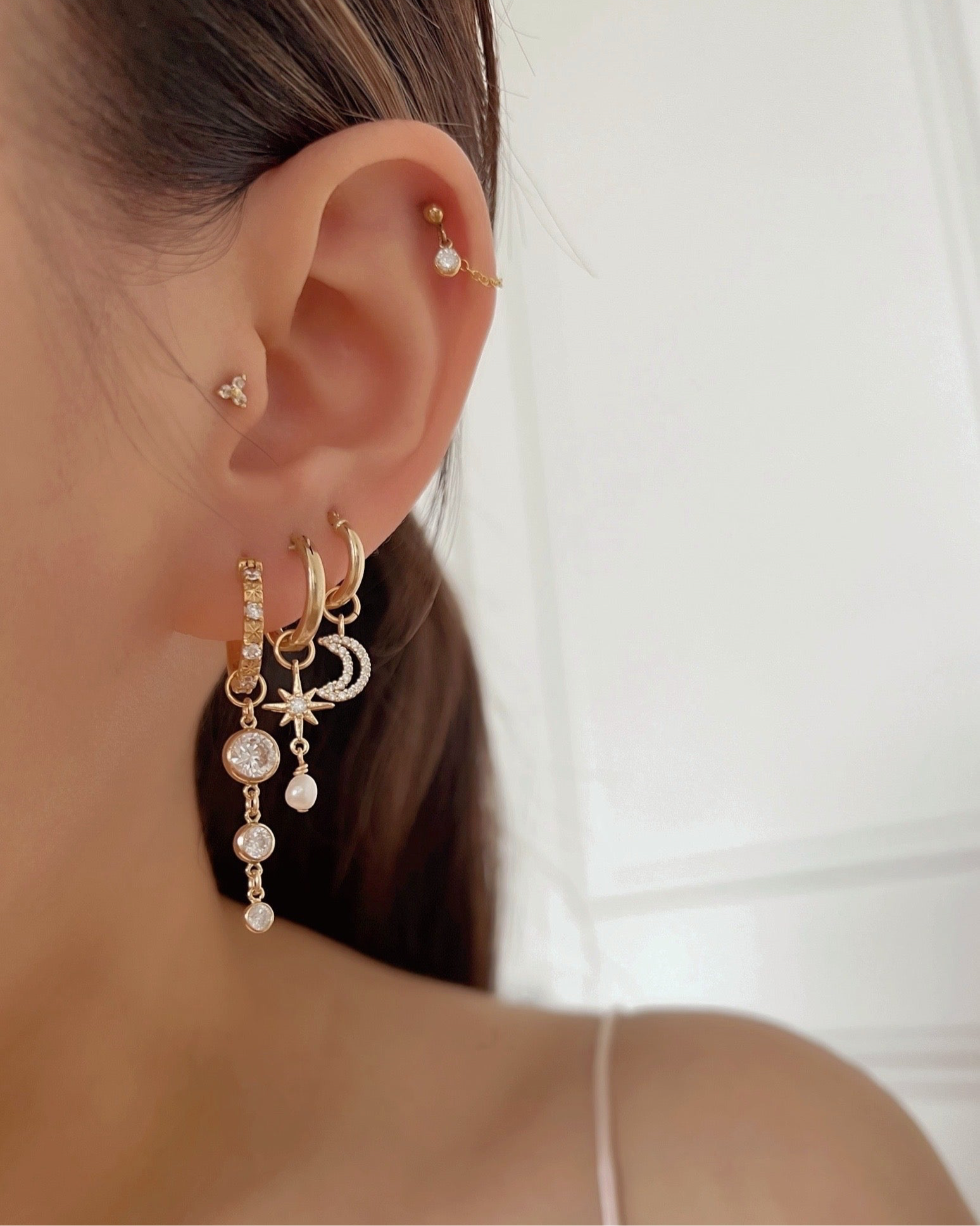 14k gold fill freshwater pearl chain stud earring on a model 