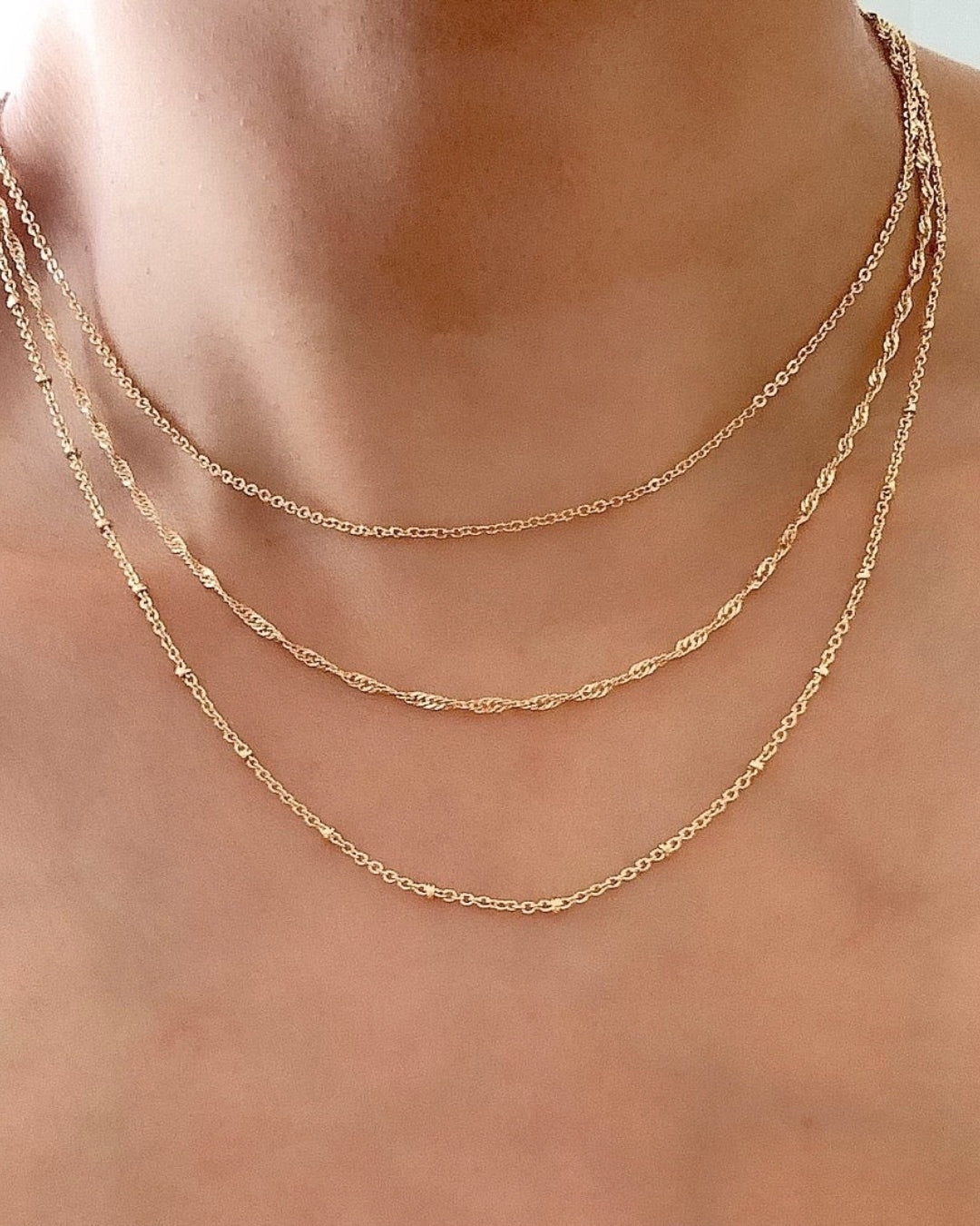 14k yellow gold fill singapore rope chain necklace on a model 