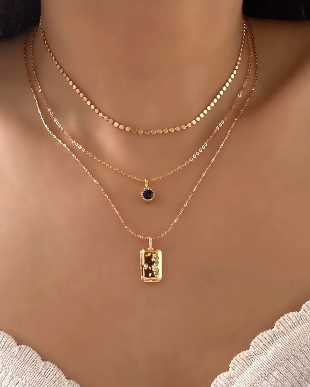 Model wearing September Birthstone Necklace, layered with Virgo Constellation Necklace and Petite Faceted Necklace. 