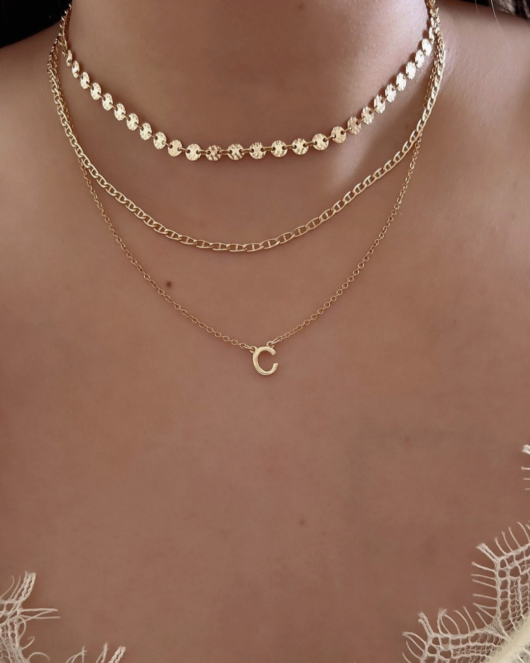 Model wearing gold-filled necklace featuring a single initial letter C