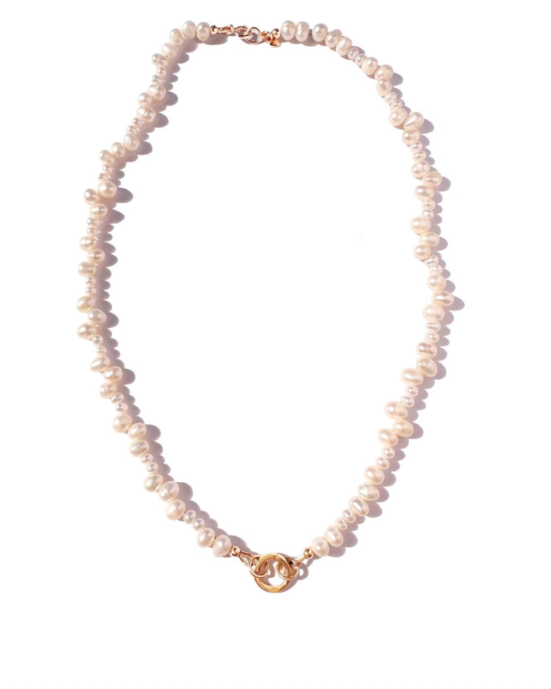 Pearl necklace with a gold clasp on a white background