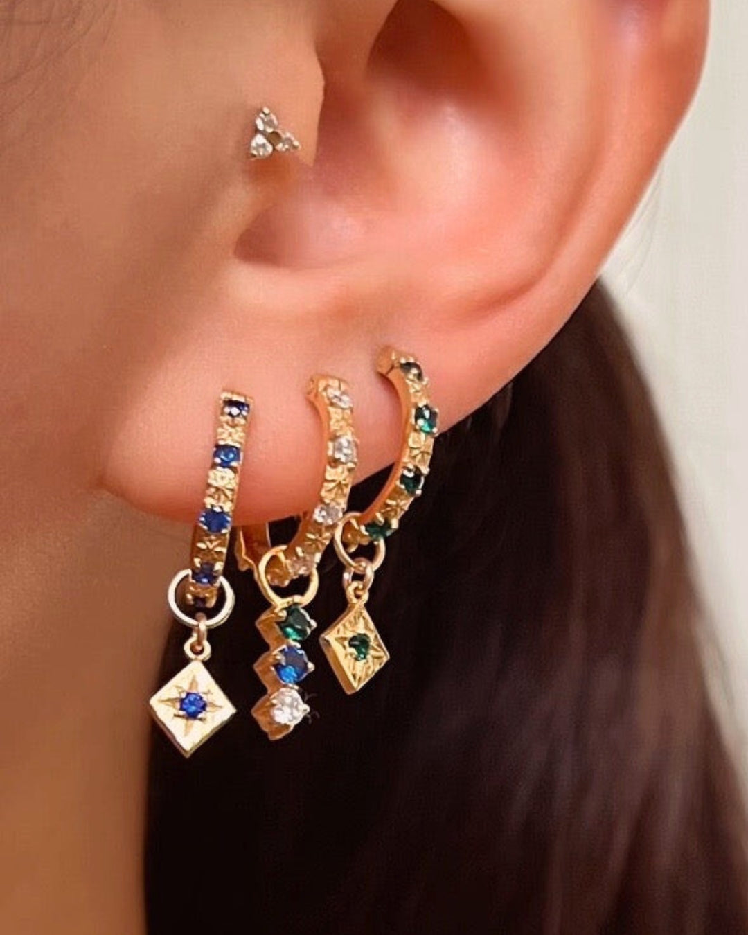 Gold Fill Sapphire Blue Star Hoops Earrings on a model 