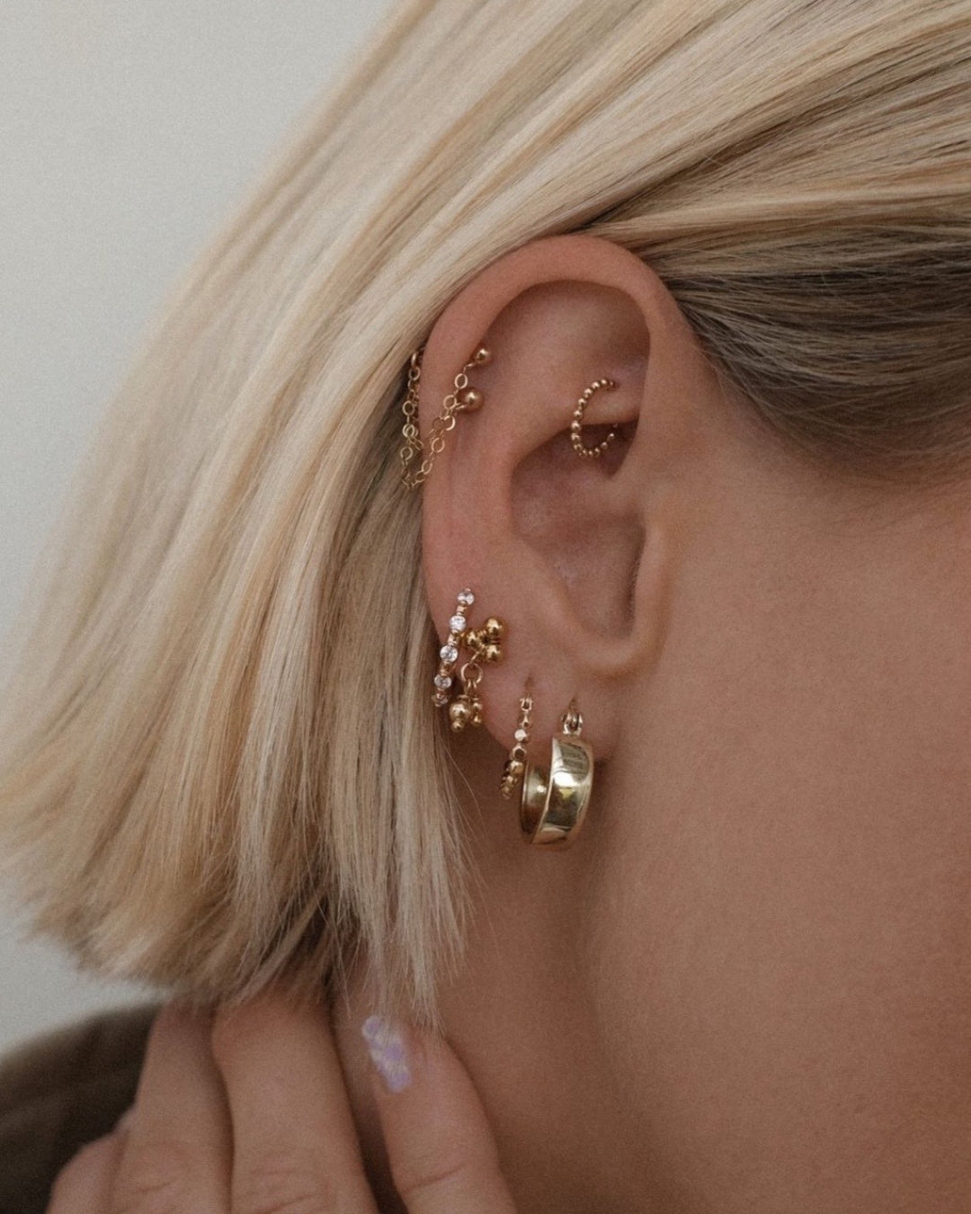 14k gold fill mini chunky bold thick hoops earrings on a model