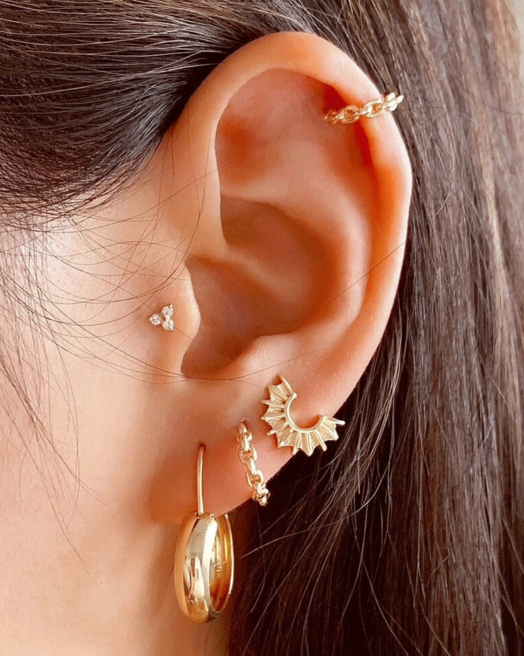 14k gold fill sunray earring studs on a model