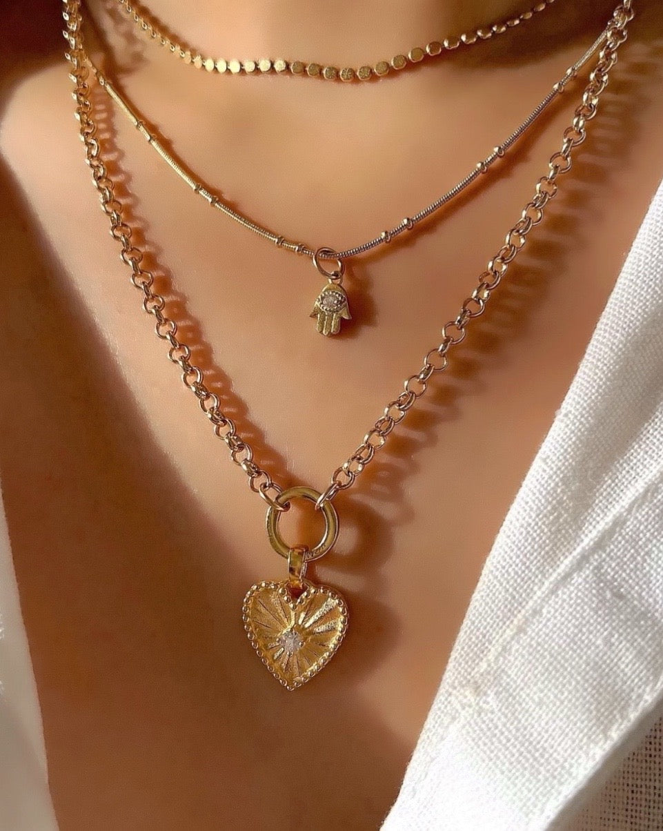 14k gold fill love heart pendant with diamond cubic zirconia centre with a Rolo annex link necklace chain on a model 