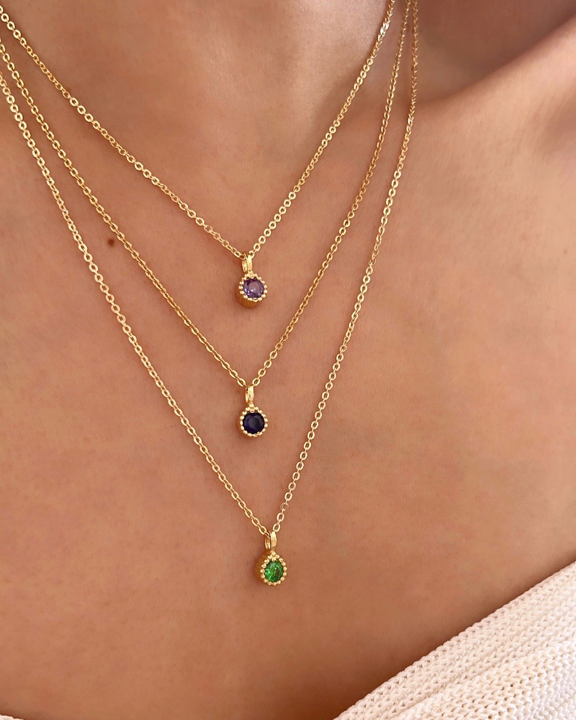 Gold May Emerald Birthstone Necklace on a model. 