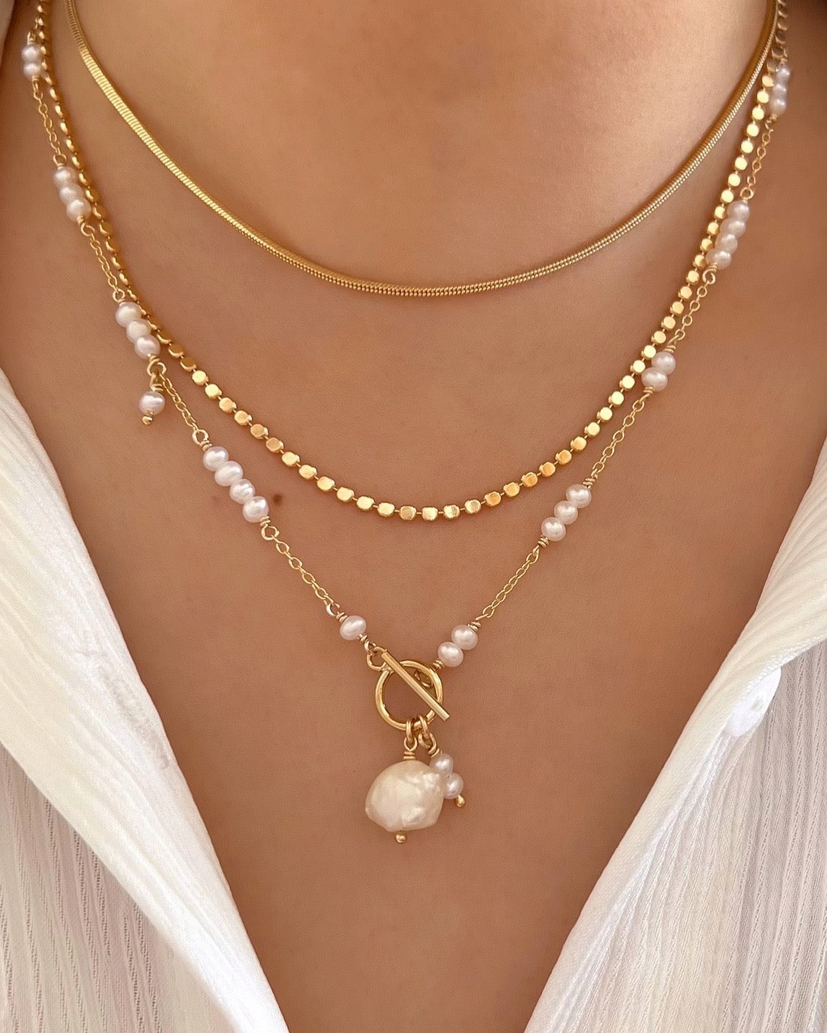 14k yellow gold fill freshwater pearl necklace on a model 