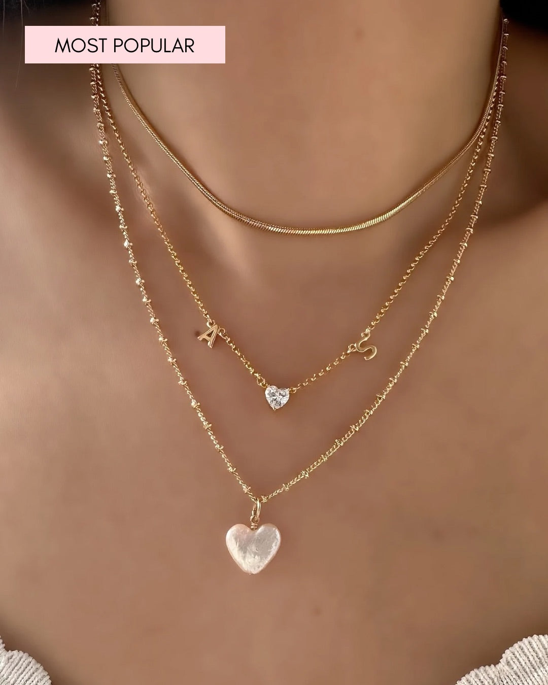 Model wearing petite initial necklace with pearl heart necklace 