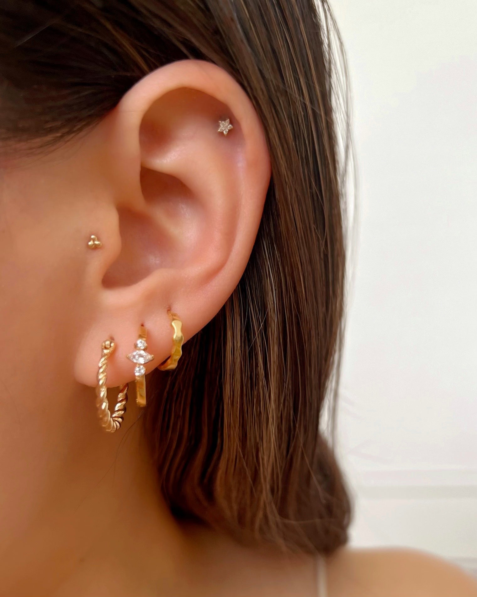 Close up of Gold Fill Croissant Hoops on a model