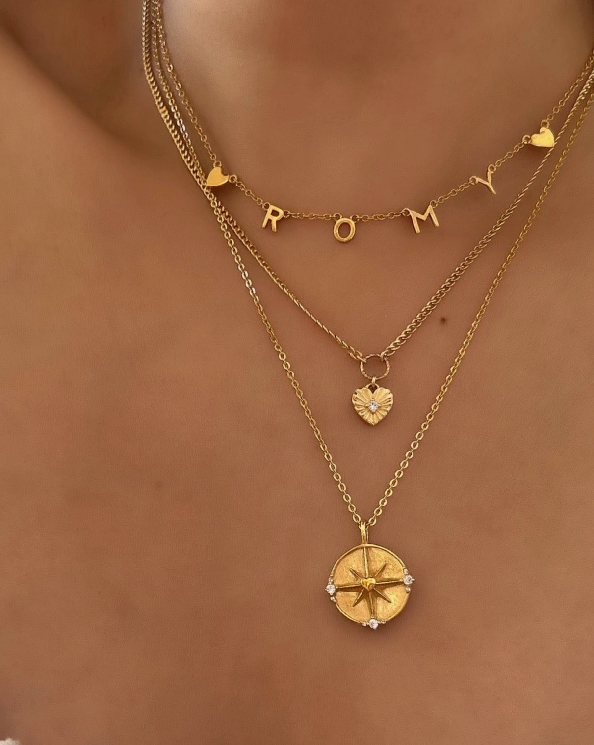 14k gold fill dreamers pendant on a necklace chain featuring a love heart centre on a North Star on a model 