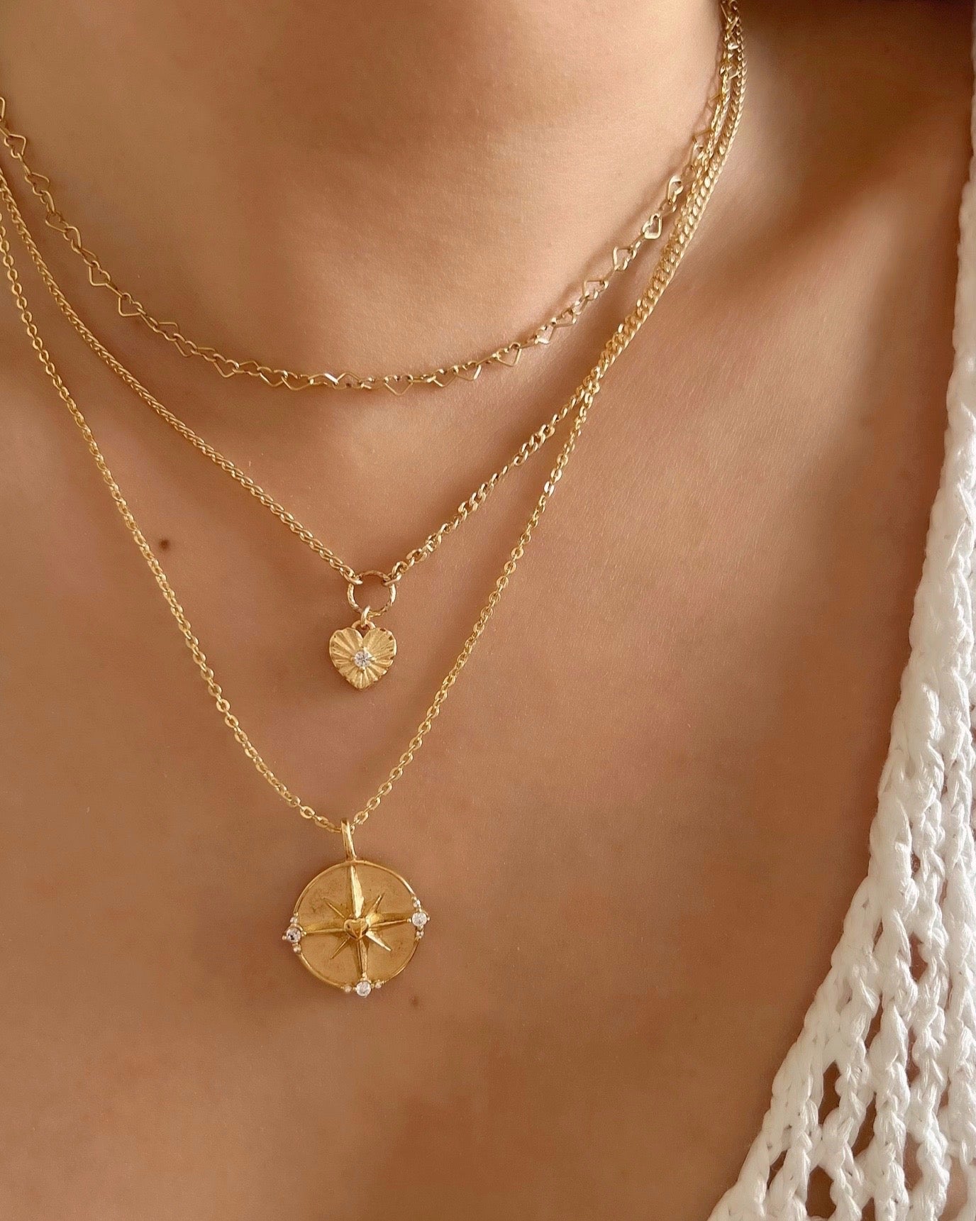 14k gold fill dreamers pendant on a necklace chain featuring a love heart centre on a North Star on a model 